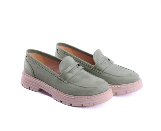 A pair of sage green suede chunky loafers