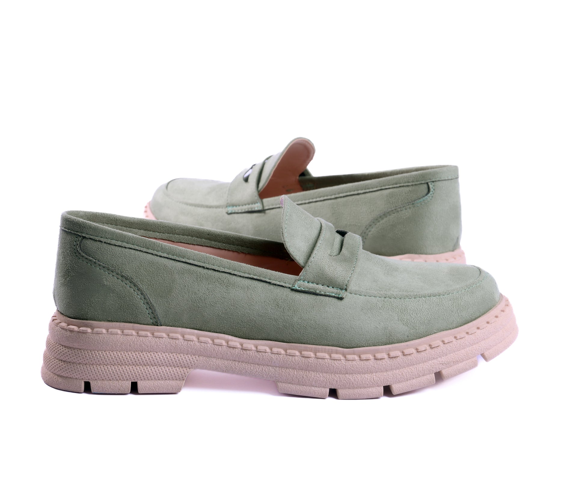 A pair of sage green suede chunky loafers