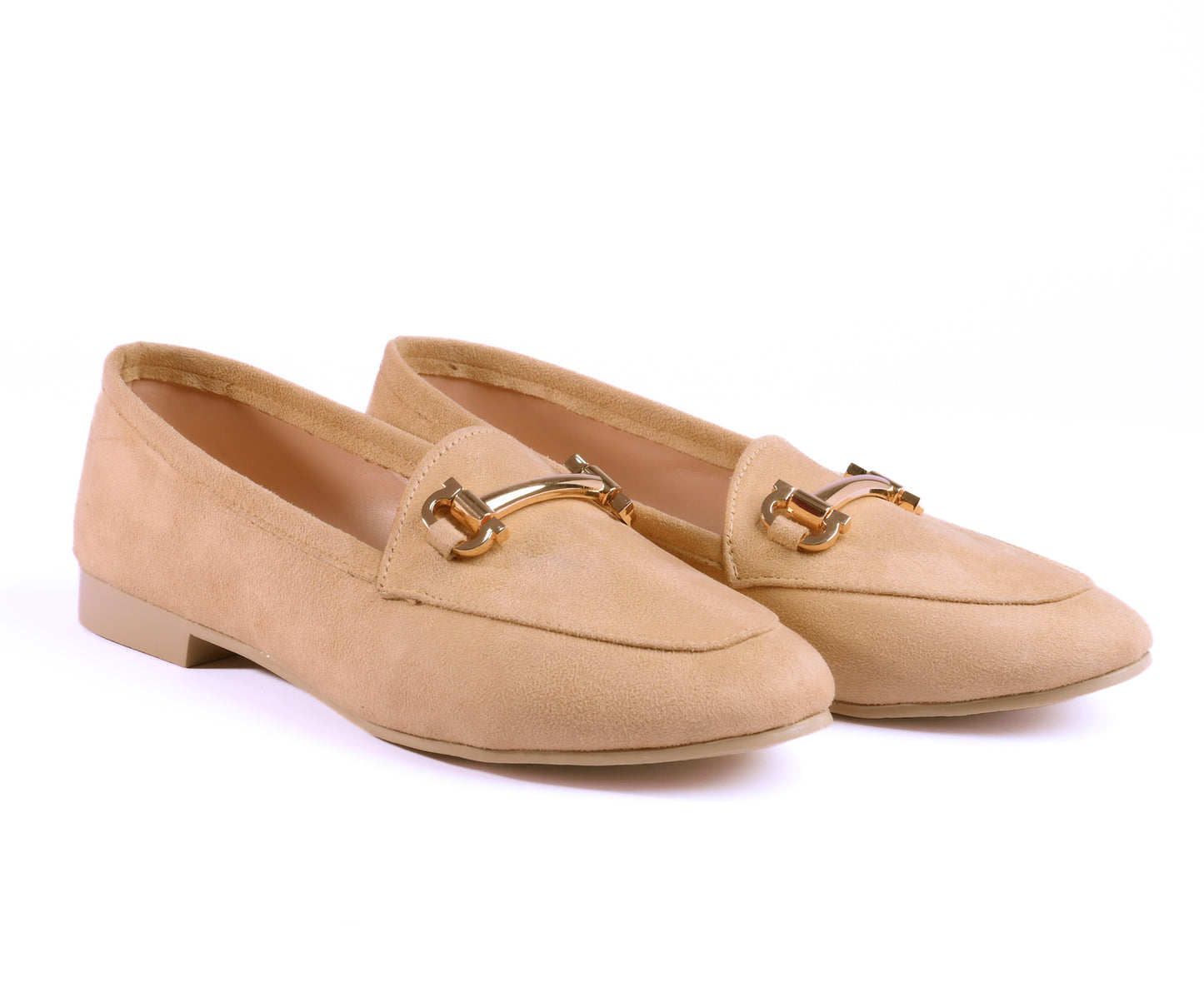 A pair of beige suede loafers with a shiny gold buckle for women
