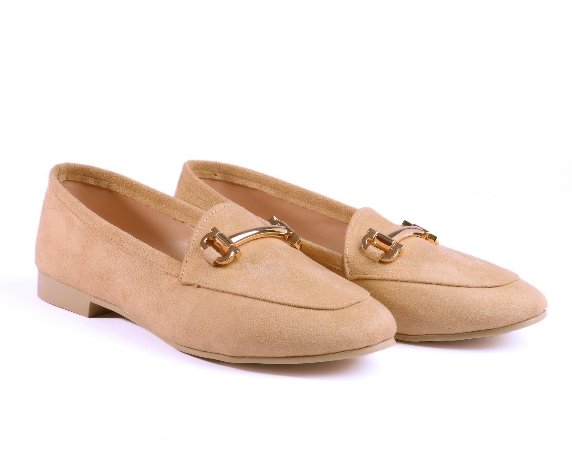 A pair of beige suede loafers with a shiny gold buckle for women