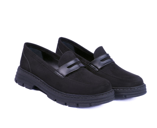 Black suede chunky loafers with a thick lug sole and leather strap.