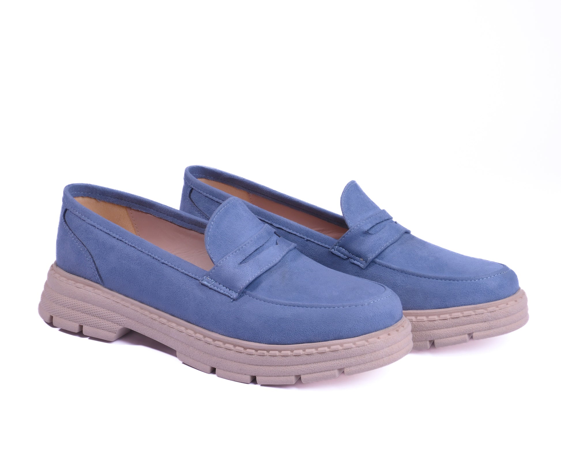 A pair of dusty blue suede chunky loafers with a beige lug sole