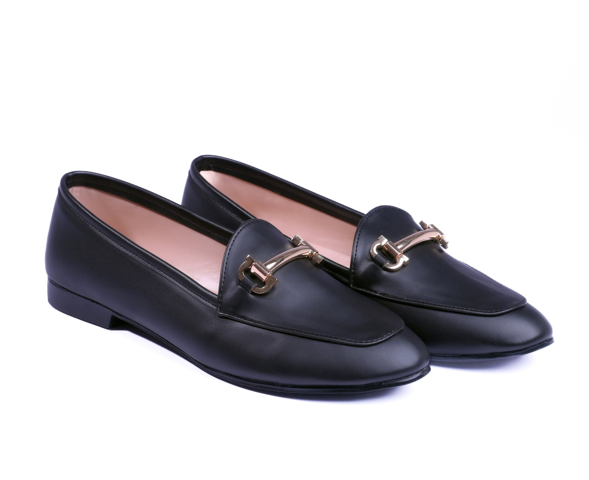 Pair of black loafers with gold buckles on a white background