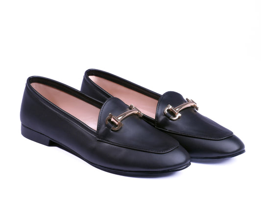 Pair of black loafers with gold buckles on a white background