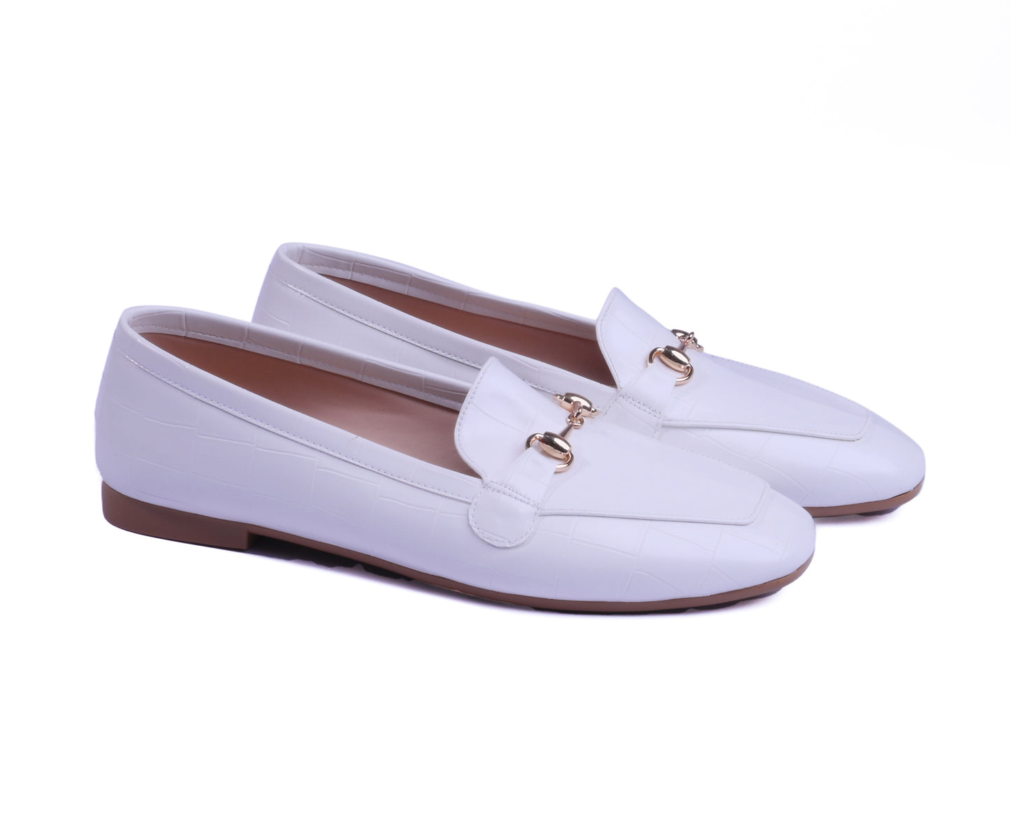A pair of white crocodile-effect loafers with a square toe and gold buckle.