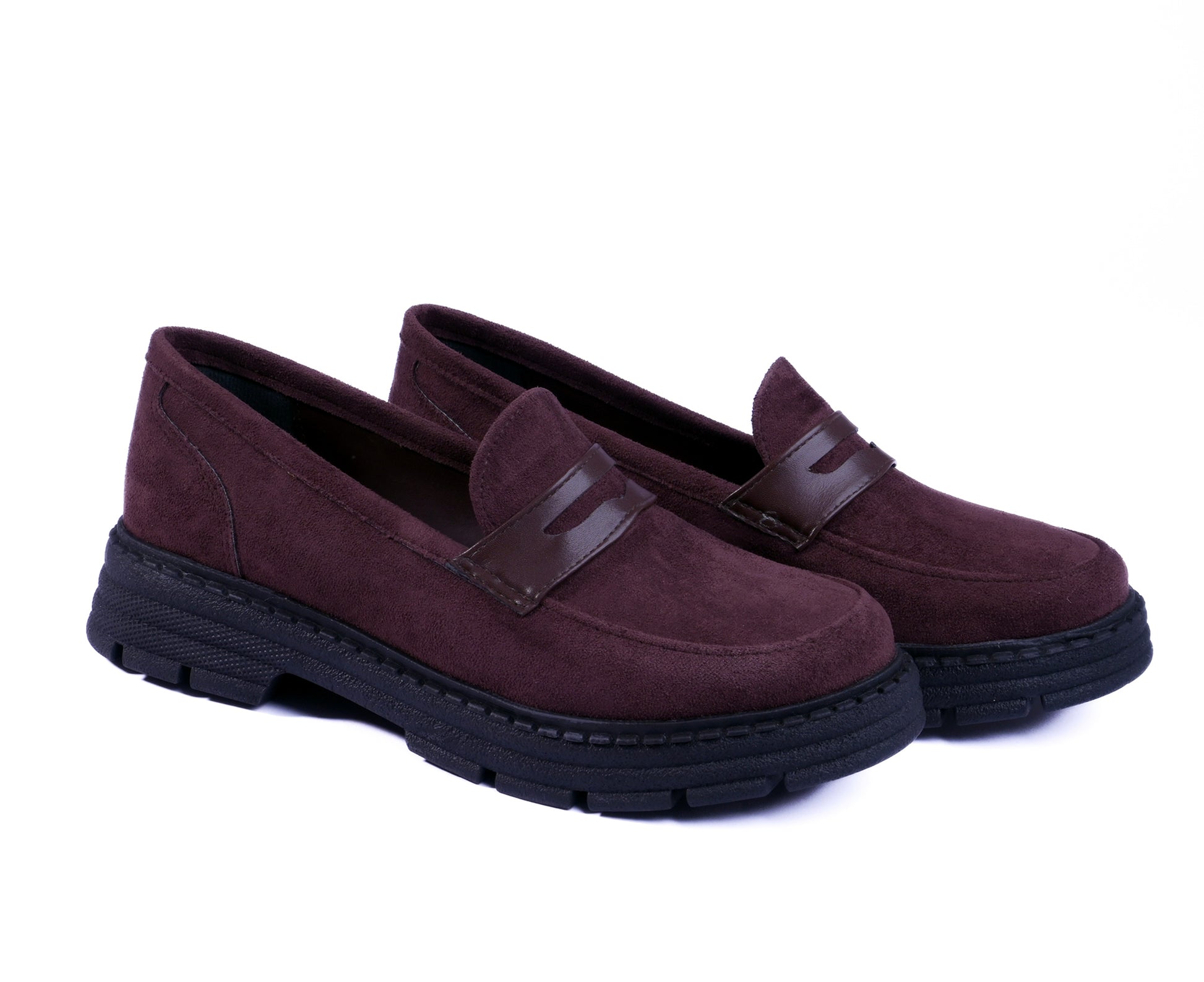 Pair of brown loafers with black soles on a white background