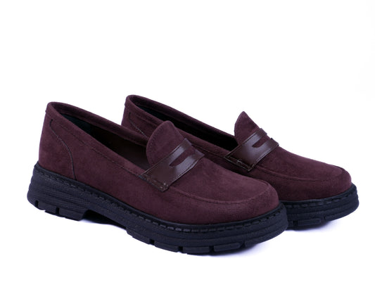 Pair of brown loafers with black soles on a white background