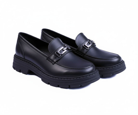A pair of black chunky loafers with a thick lug sole and silver chain detail.